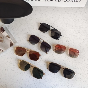 Detailed view of five multi-colored kids polygonal sunglasses with gold metal frames