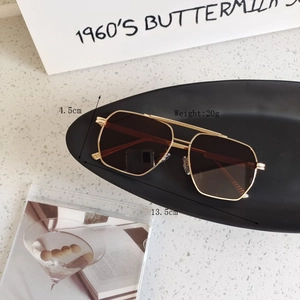 Close-up of geometric gold metal frames with measurements and adjustable nose pads