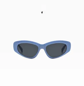 Detail view of bold blue cat-eye sunglasses with flat thick frame and UV lenses