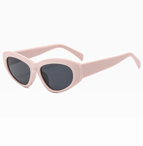 Close-up of pink cat eye sunglasses with dark lenses and durable plastic frames
