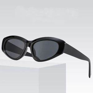 Retro oval black frame sunglasses for women with UV protection on white pedestal