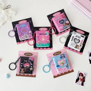 Set of six colorful Y2K mini photo album keychains in diverse aesthetic designs