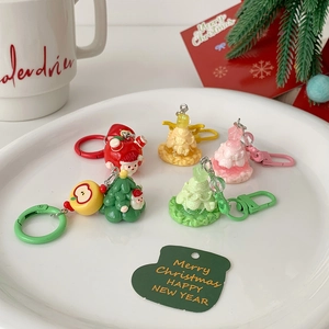 Detailed view of resin Christmas keychains with glitter finish on a decorative tray