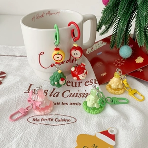 Cartoon Christmas charms for bags and keys featuring resin Santa and tree figures