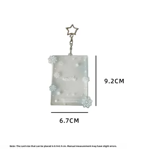 Macro detail of acrylic photocard holder with snowflake glitter and star clip