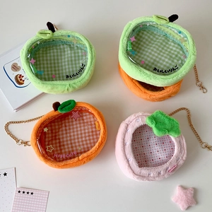 Close-up of plush fruit bags with transparent windows and gold metal chain straps