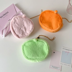 Three plush strawberry-themed mini bags in pink, orange, and green with gold chains