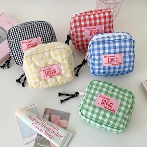 Quilted heart pattern cosmetic bags in pastel colors on a white minimalist background