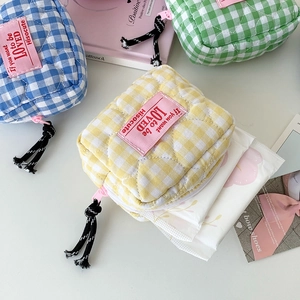 Detailed view of quilted cotton cosmetic bags in blue yellow and green colors
