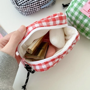 Quilted checkered cosmetic bag in red, green, and black cotton fabric with zipper