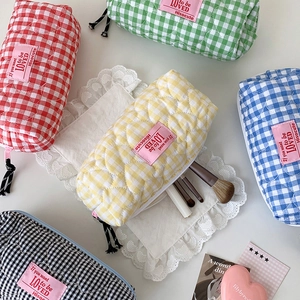 Detailed close-up of colorful heart-quilted stationery pouches with black zipper pulls