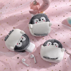 Detail of cute plush penguin earphone cases showing gray and white soft fabric texture