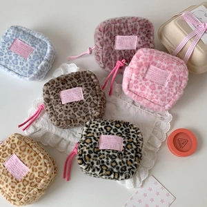 Flat lay of six colorful leopard print plush mini bags with fuzzy faux fur texture