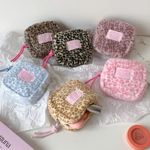 Detail of plush leopard print storage bags in various colors for makeup and accessories