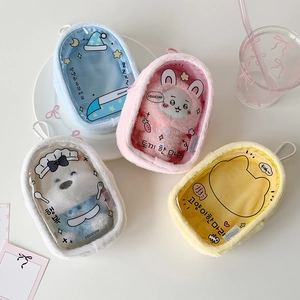 Macro view of pastel plush pouch charms with clear windows and cartoon patterns