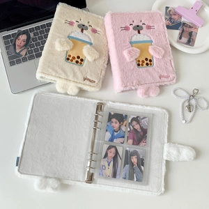 Close-up of plush cartoon binder cover with embroidered cute seal and metal rings