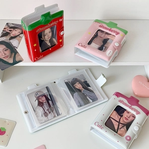 Close-up of strawberry-themed 3-inch photo album with transparent window and buckle