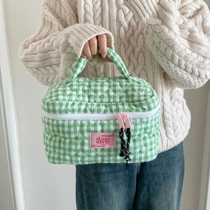 Quilted green checkered makeup bag with heart stitching and pink dual zippers