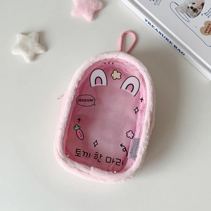 Detail of pink plush doll display bag with clear window and cute carrot patterns