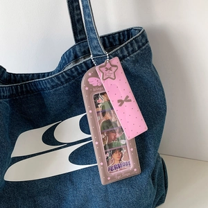 Cartoon angel star long card holder with wings motif hanging on a denim bag