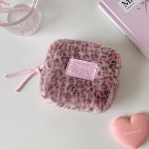 Detail of pink leopard plush pouch with Hisocute label and soft textured fur material