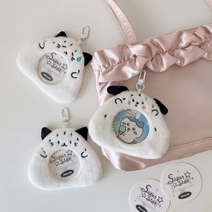 Close-up of white plush dog-shaped card holder charm with clear window and cute ears