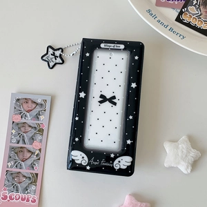 Close-up of black photo album featuring star patterns and transparent cover window