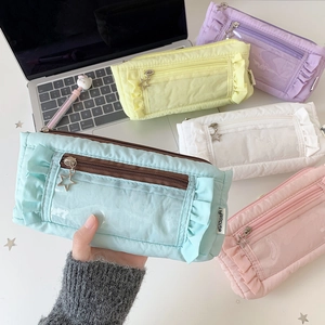 Detail of pleated pencil cases with star zippers and clear windows in pastel colors