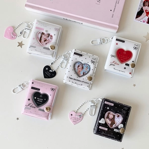 Detail of mini 2-inch heart photo albums with PVC windows and matching pendants