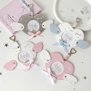 Heart-shaped winged card holder keychain in pastel colors with star patterns