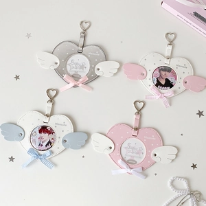 Detail view of heart-shaped photo card holders with cute angel wings and bowknots