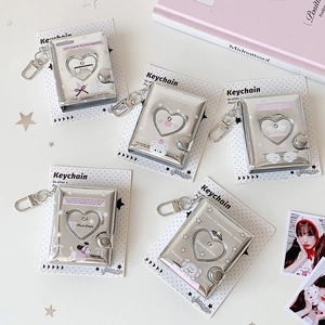 Mini silver heart cutout photo album keychain with cute cartoon puppy and bear designs
