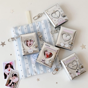 Detail of 2-inch silver heart cutout photo albums with metallic shine and cute star patterns