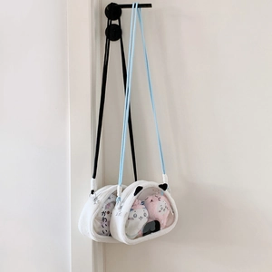 Close-up of white plush crossbody bag with transparent PVC window for doll display