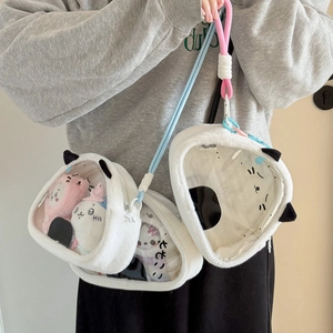 Detail showing plush itabag with cat-ear shape and transparent window for dolls