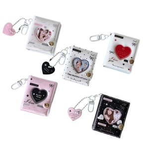Mini 2-inch photocard binders with heart cutout windows and metallic keychains