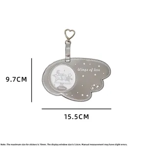 Close-up of gray wing-shaped PU leather badge holder with heart buckle and clear window