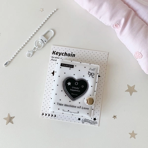 Detail of a 2-inch heart mini photo album with star chain and lobster clasp accessory