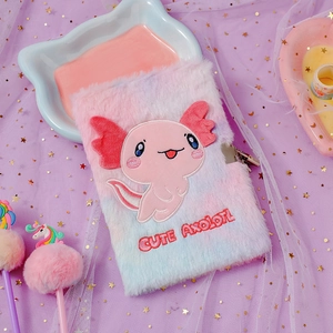 Detail of pink and blue plush axolotl diary featuring a metal heart-shaped lock and key