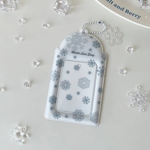 Detailed view of translucent PVC card holder with snowflakes and white beaded chain