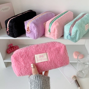 Close-up of colorful plush pencil cases with Lucky gate labels and round zipper pulls