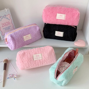 Detailed view of plush storage bags in purple, pink, black and mint green with zippers