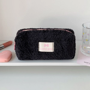 Macro detail of plush black fuzzy pencil case with pink zipper and Lucky Gate patch
