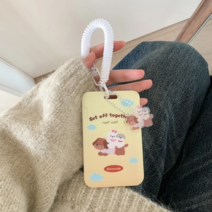 Handheld view of a yellow cartoon puppy ID card holder with white spring wrist strap