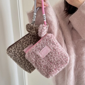 Leopard print plush cosmetic bag with soft faux fur and braided handle in brown and pink