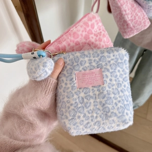 Pink and blue leopard print plush cosmetic bags with pompom zipper and wrist strap