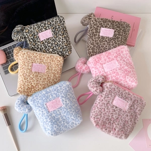 Plush leopard print makeup bags in six colors with stylish pompom charms and wristlet