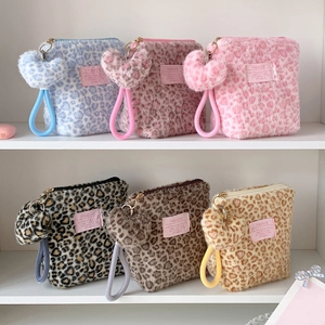 Detailed display of plush leopard print makeup bags in six colors with heart charms
