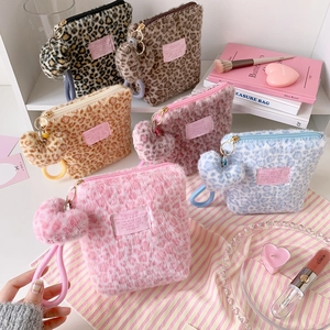Leopard print plush makeup bags with heart charms and woven straps in multiple colors