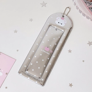 Detail of silver star pattern card holder with a cute white bear and metal bead chain